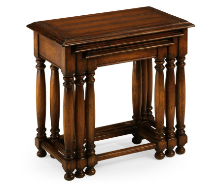 Nest of three walnut tables with plank tops